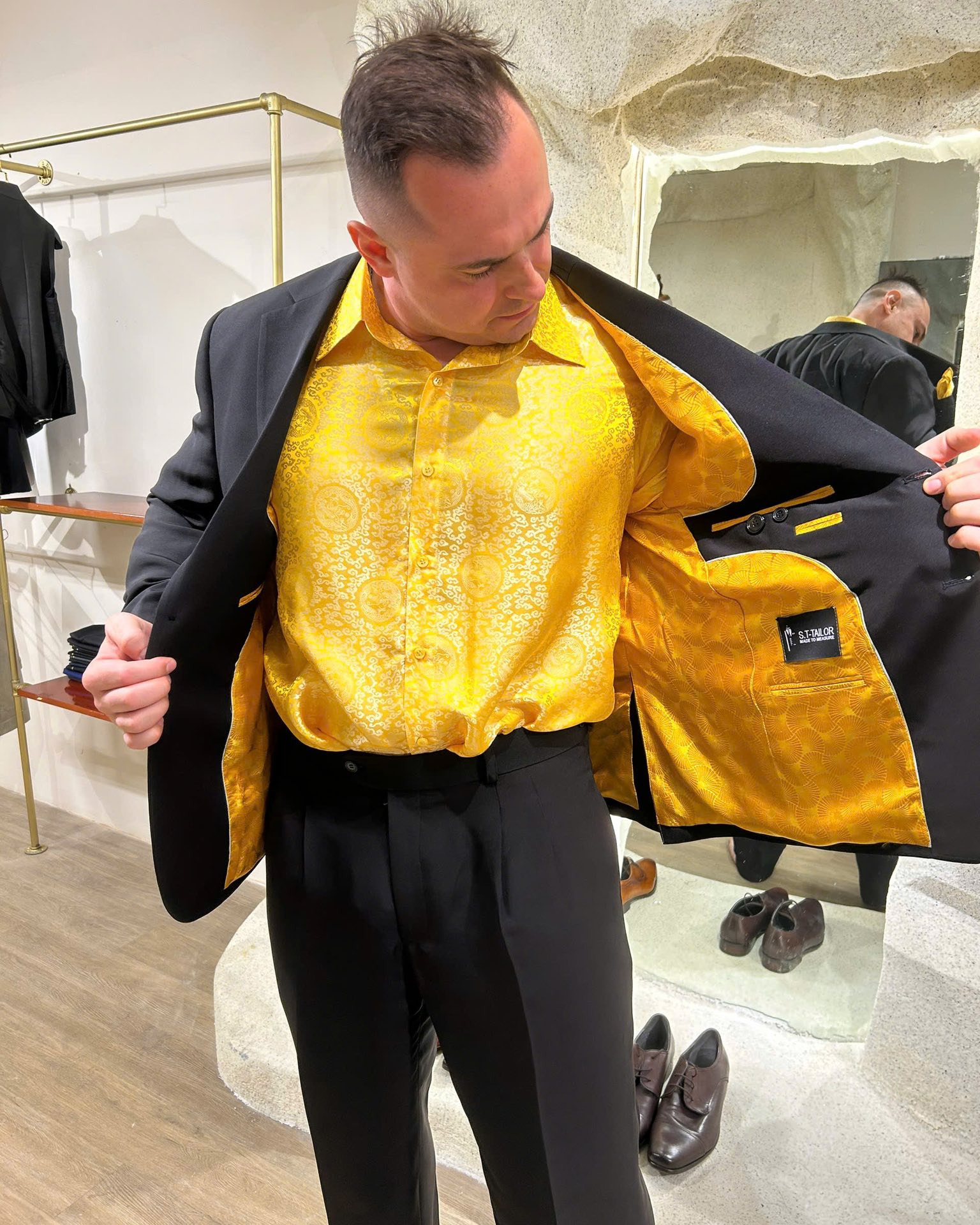 Client opening a jacket to show gold lining | Khách hàng mở áo khoác để thể hiện lớp lót vàng