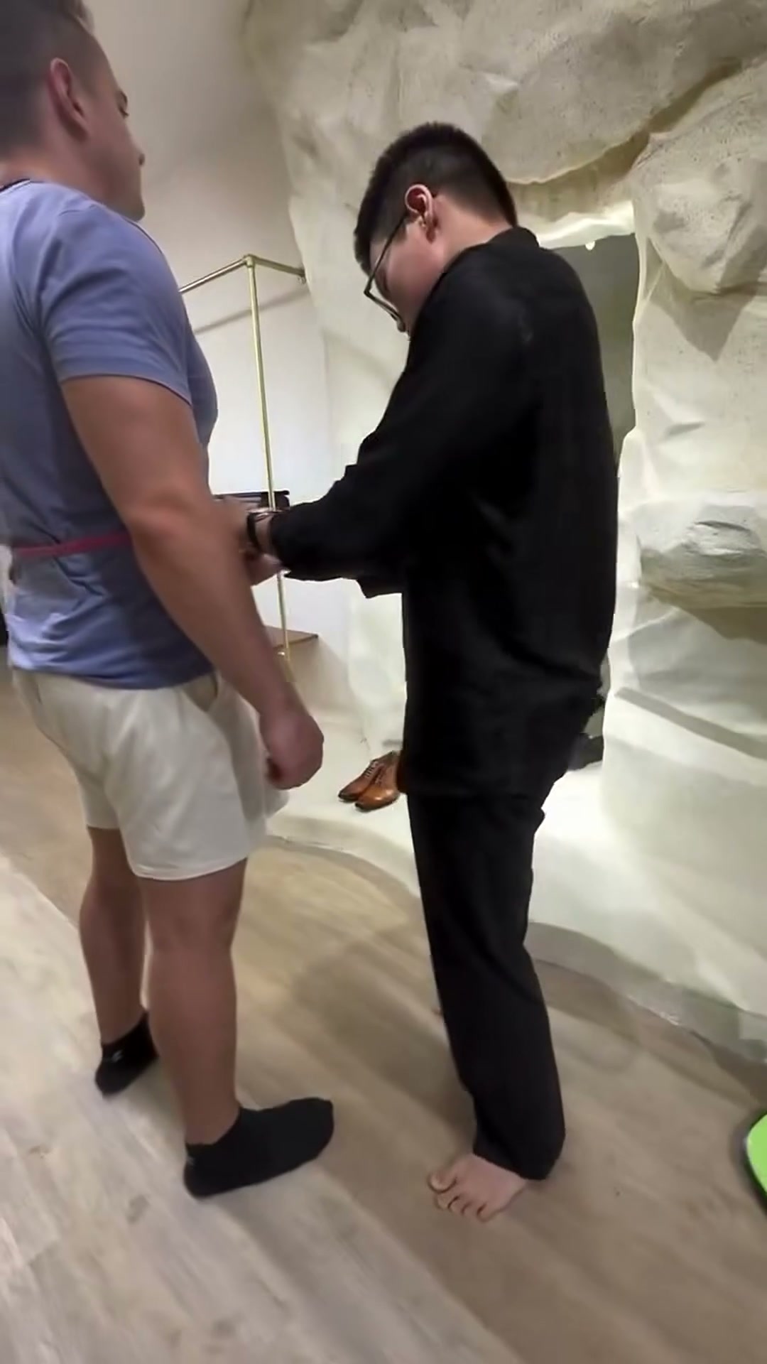 Tailor measuring a client during a fitting session | Thợ may lấy số đo khách hàng trong buổi thử đồ