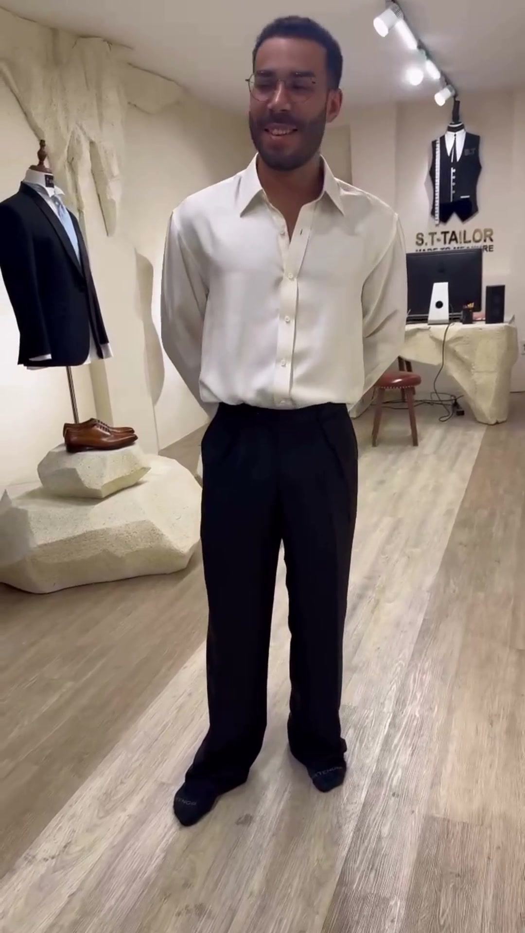 Client trying a white shirt and black trousers | Khách hàng thử sơ mi trắng và quần đen