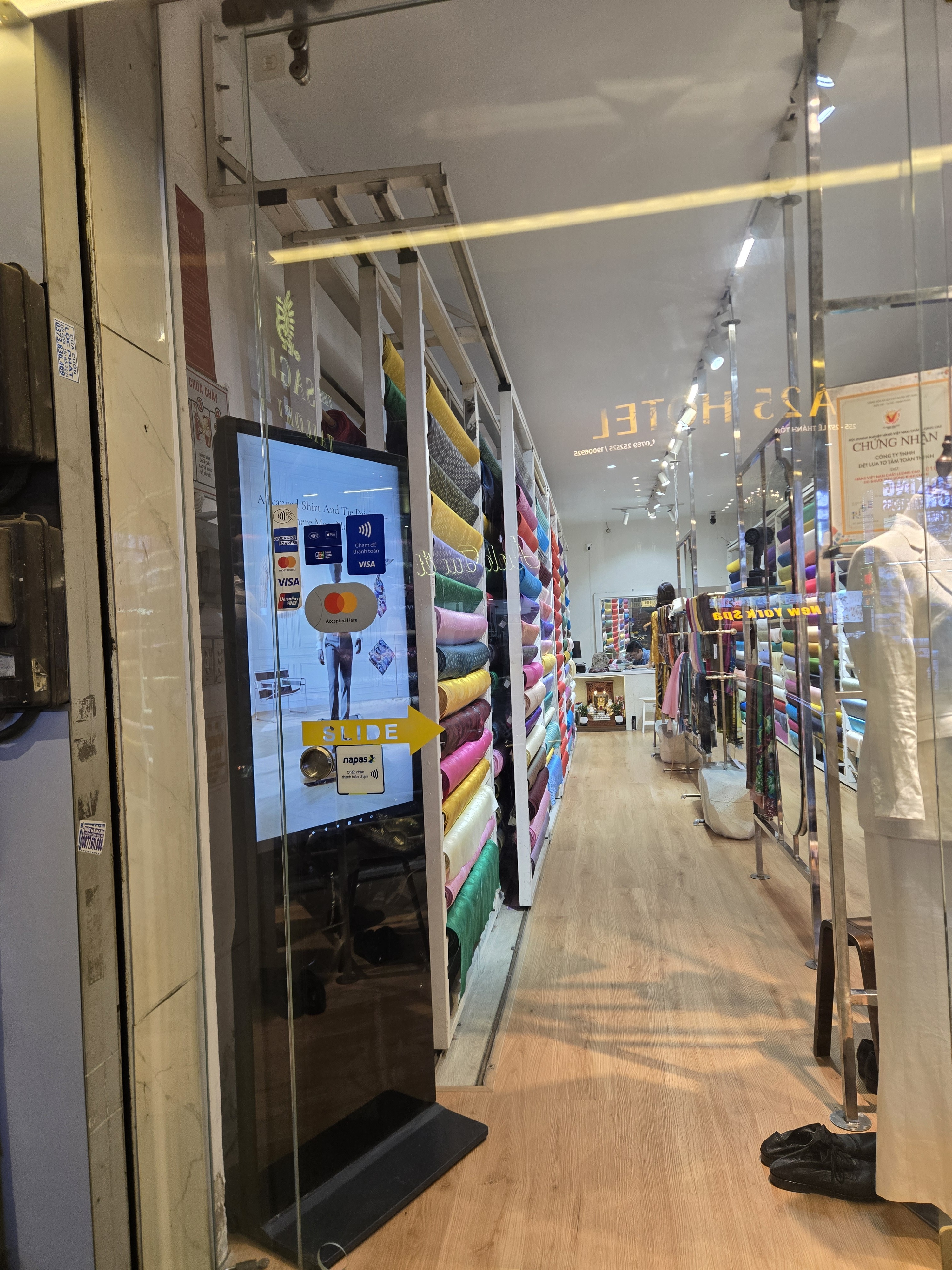 Showroom aisle with fabric and garments in the evening | Lối đi showroom với vải và trang phục vào buổi tối