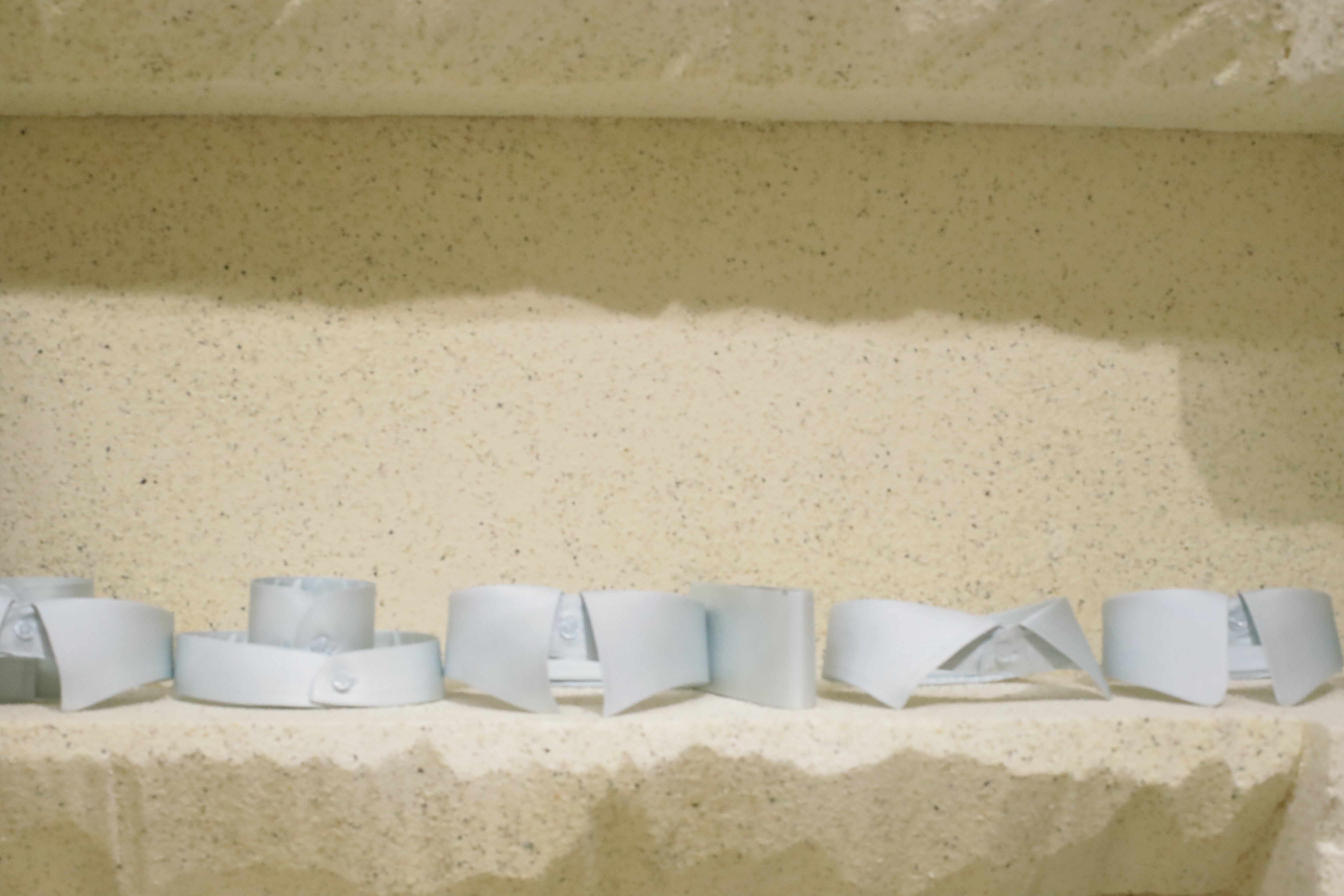 Tailoring accessories displayed on a shelf | Phụ kiện may đo trưng bày trên kệ