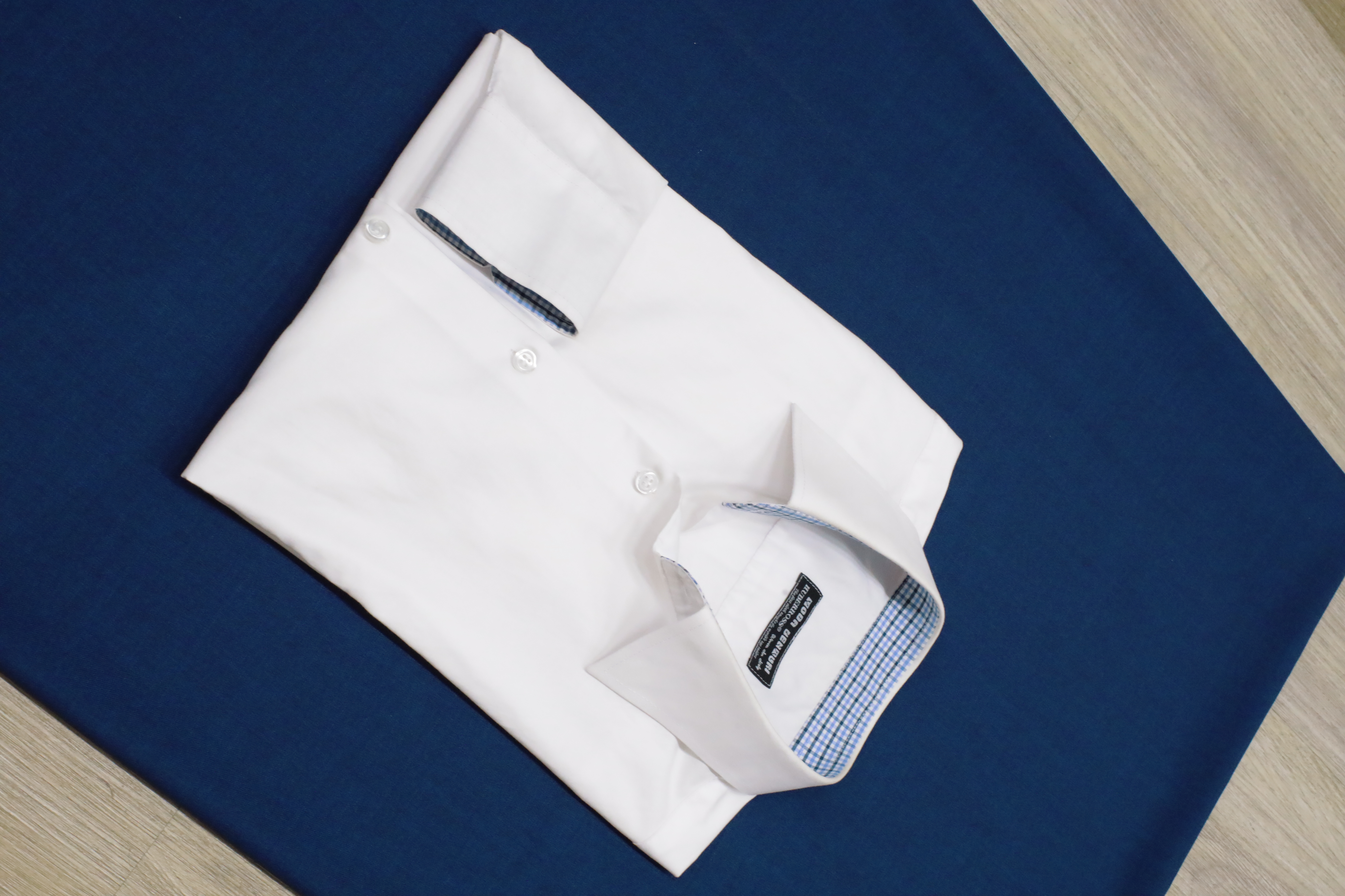 White tailored shirt with checked inner collar detail | Sơ mi trắng may đo với chi tiết cổ trong caro