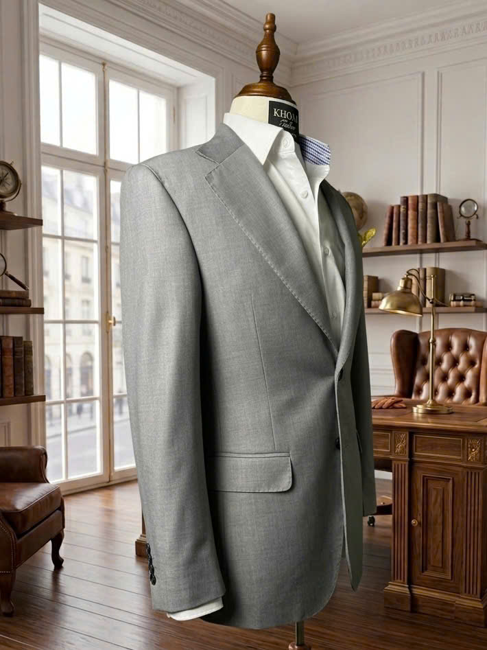 Grey tailored suit on a mannequin by a window | Suit xám may đo trên mannequin cạnh cửa sổ
