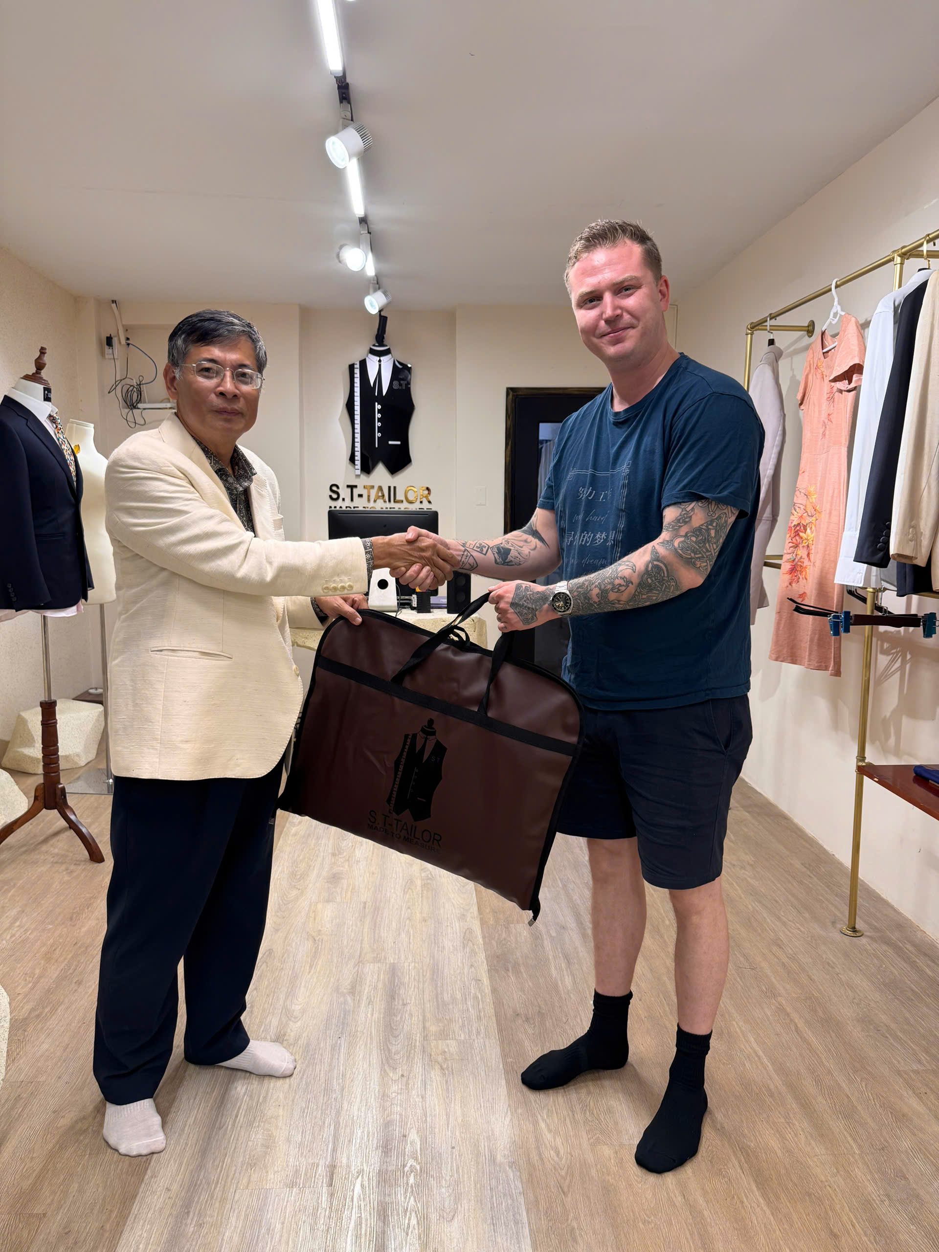 International client receiving a garment at S.T Tailor | Khách hàng quốc tế nhận trang phục tại S.T Tailor