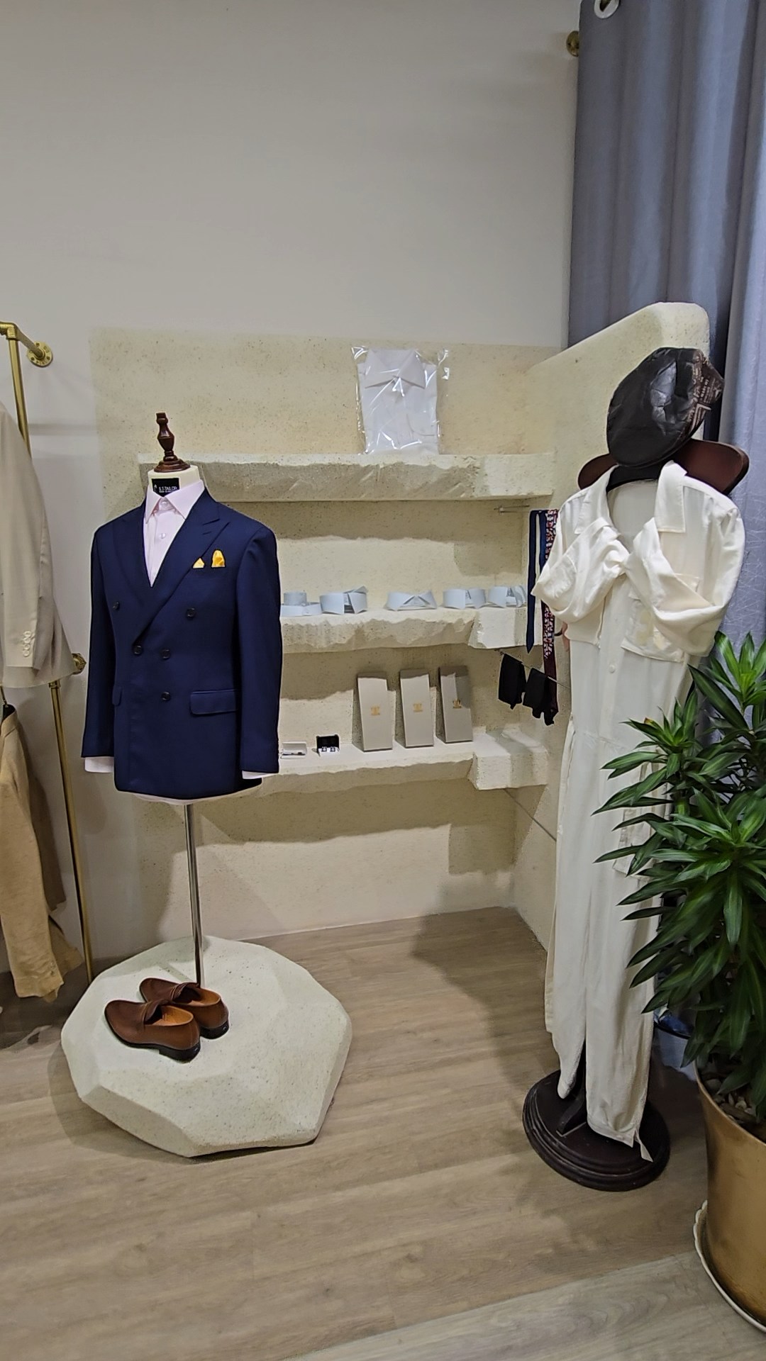 Navy suit and womenswear displayed inside S.T Tailor | Suit xanh navy và trang phục nữ trưng bày tại S.T Tailor