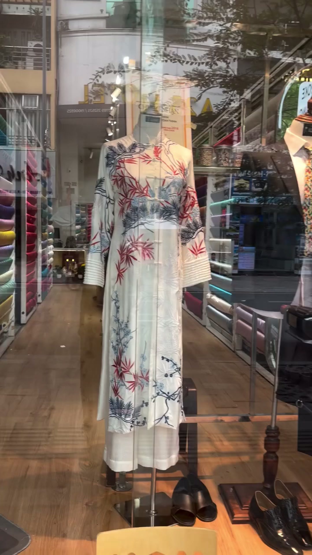 Floral womenswear displayed in the showroom window | Trang phục nữ họa tiết hoa trưng bày tại cửa sổ showroom